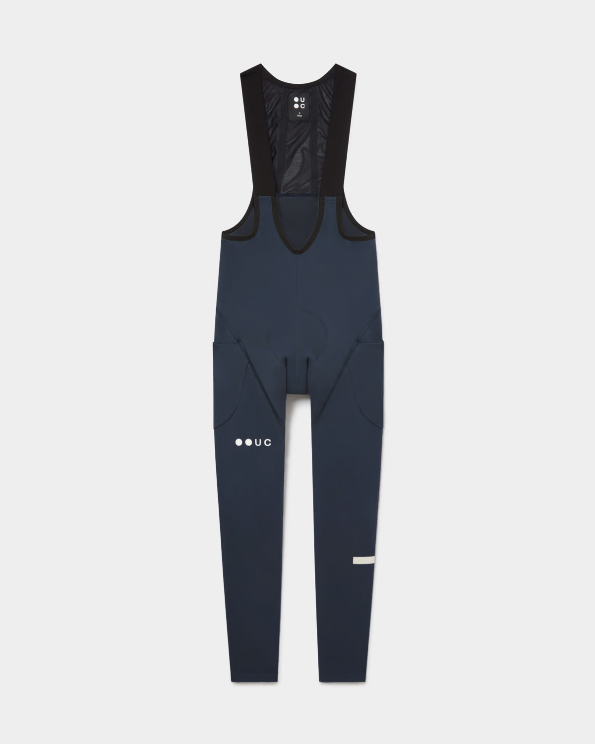 Flatlay of the Men's Mono Cargo Bib Tight in Eclipse Navy: mesh upper bib, side thigh cargo pockets and UC leg logo.