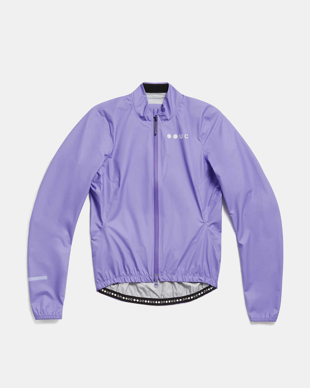 Flatlay of the Women's Mono Rain Jacket in Cloud Lilac: high collar, full-length zip, UC chest logo, elasticated hem.
