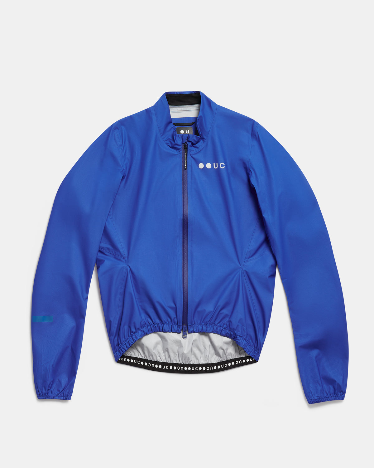 Flatlay of the Men's Mono Rain Jacket in Vivid Blue: ripstop shell, full-length zip and UC chest logo.