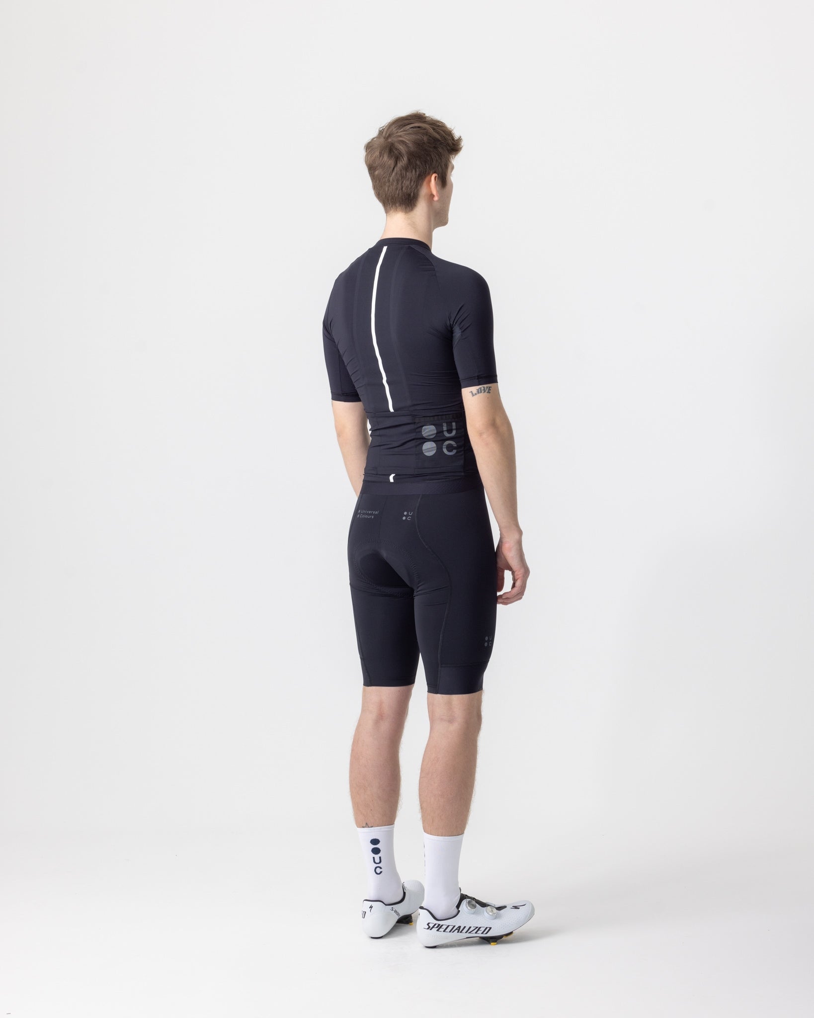 Back view: Men's Mono Short Sleeve Jersey in Black with reflective white spine stripe and mesh rear pocket panel.