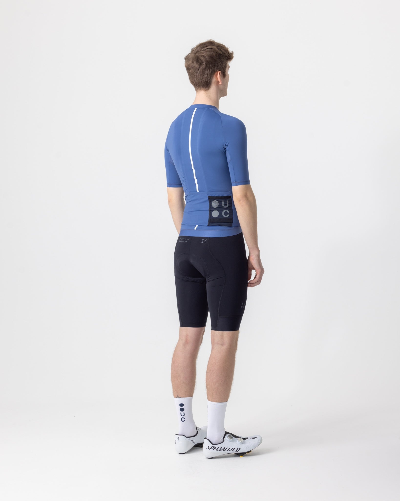 Back view: French Blue Men's Mono Short Sleeve Jersey with reflective white spine stripe and sheer mesh rear pocket.