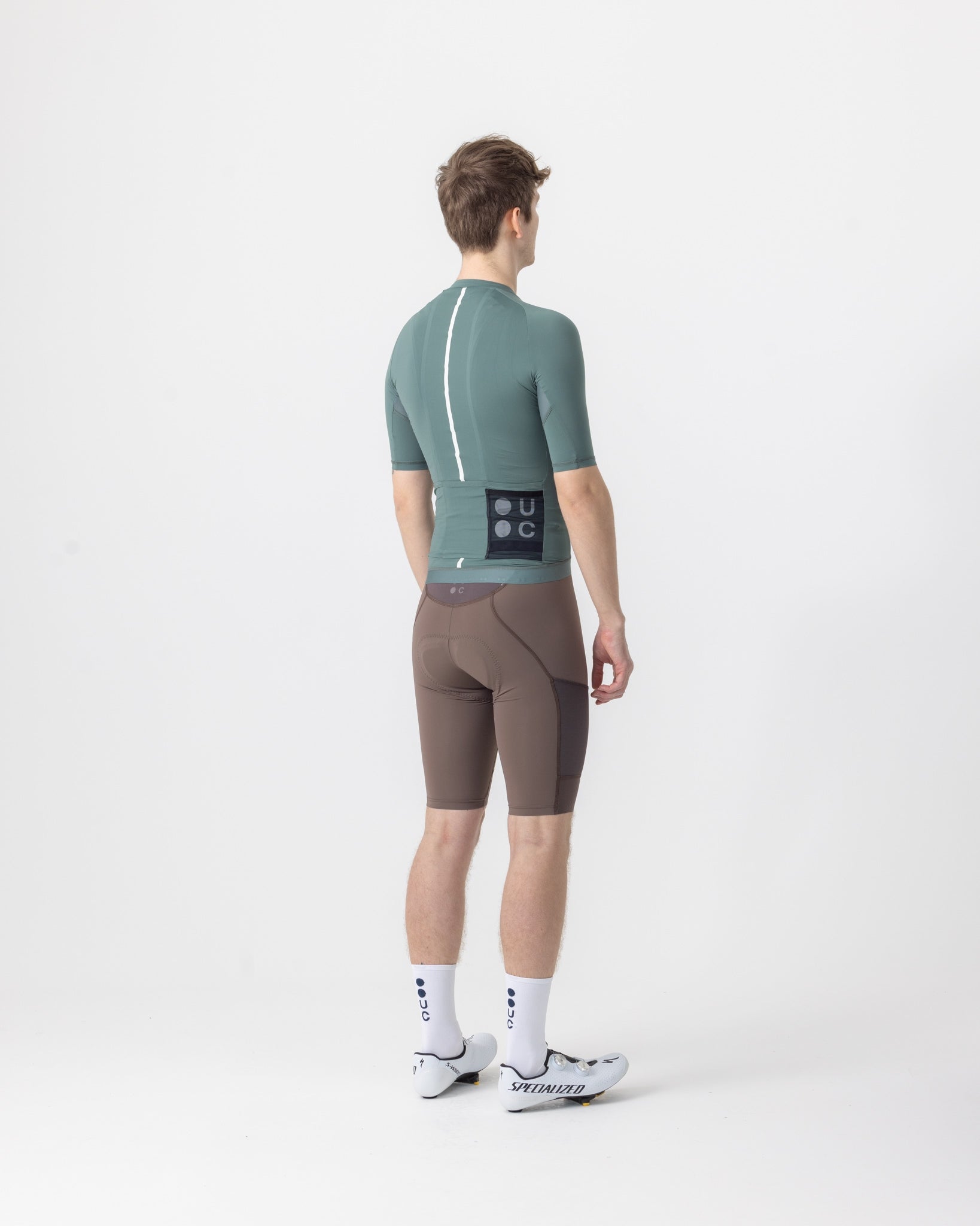 Back view: Men's Mono Short Sleeve Jersey in Green Daze with reflective spine stripe and three rear pockets.
