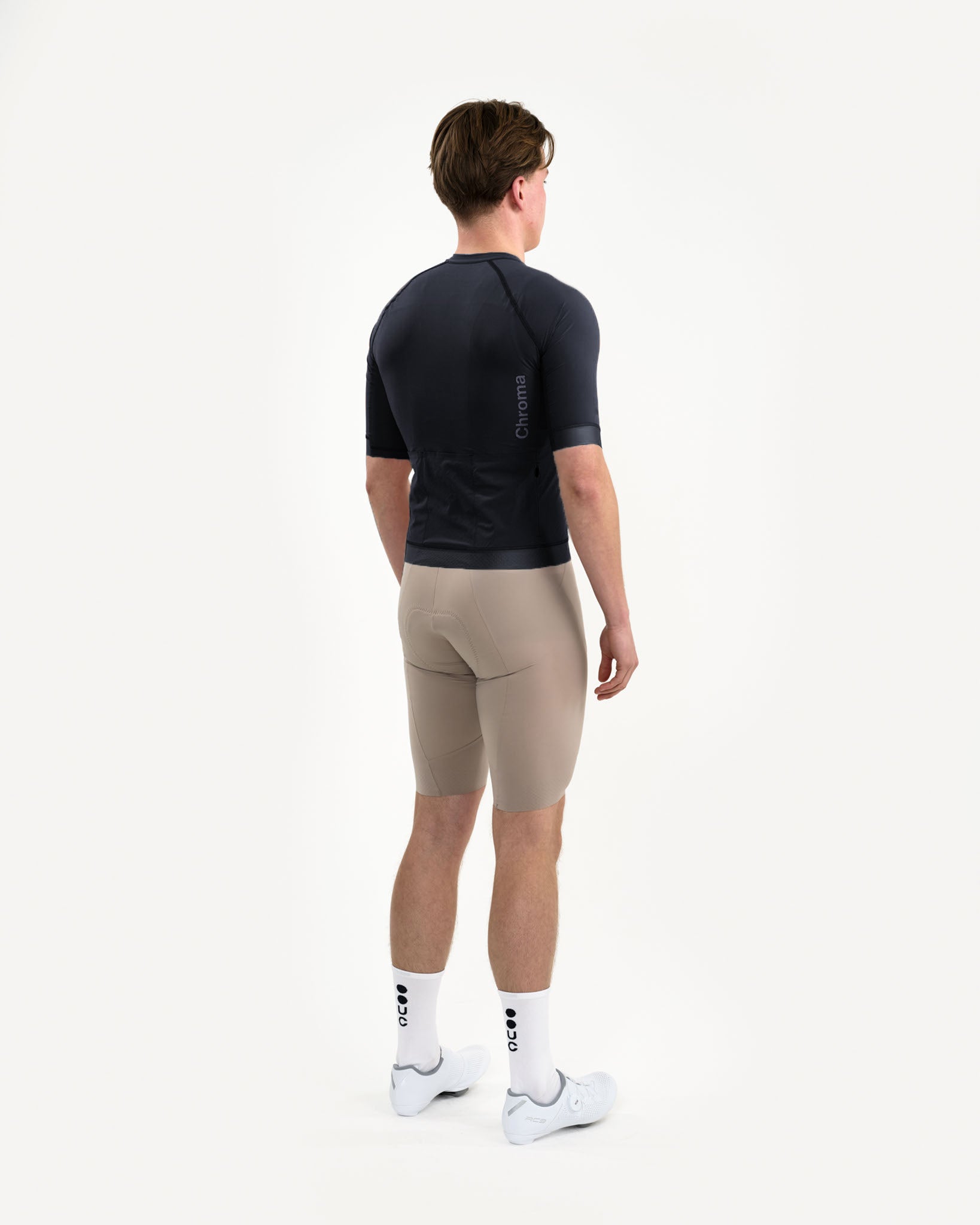 Back view on model: Men's Chroma Jersey in Black with tonal Chroma shoulder wordmark and three rear cargo pockets.