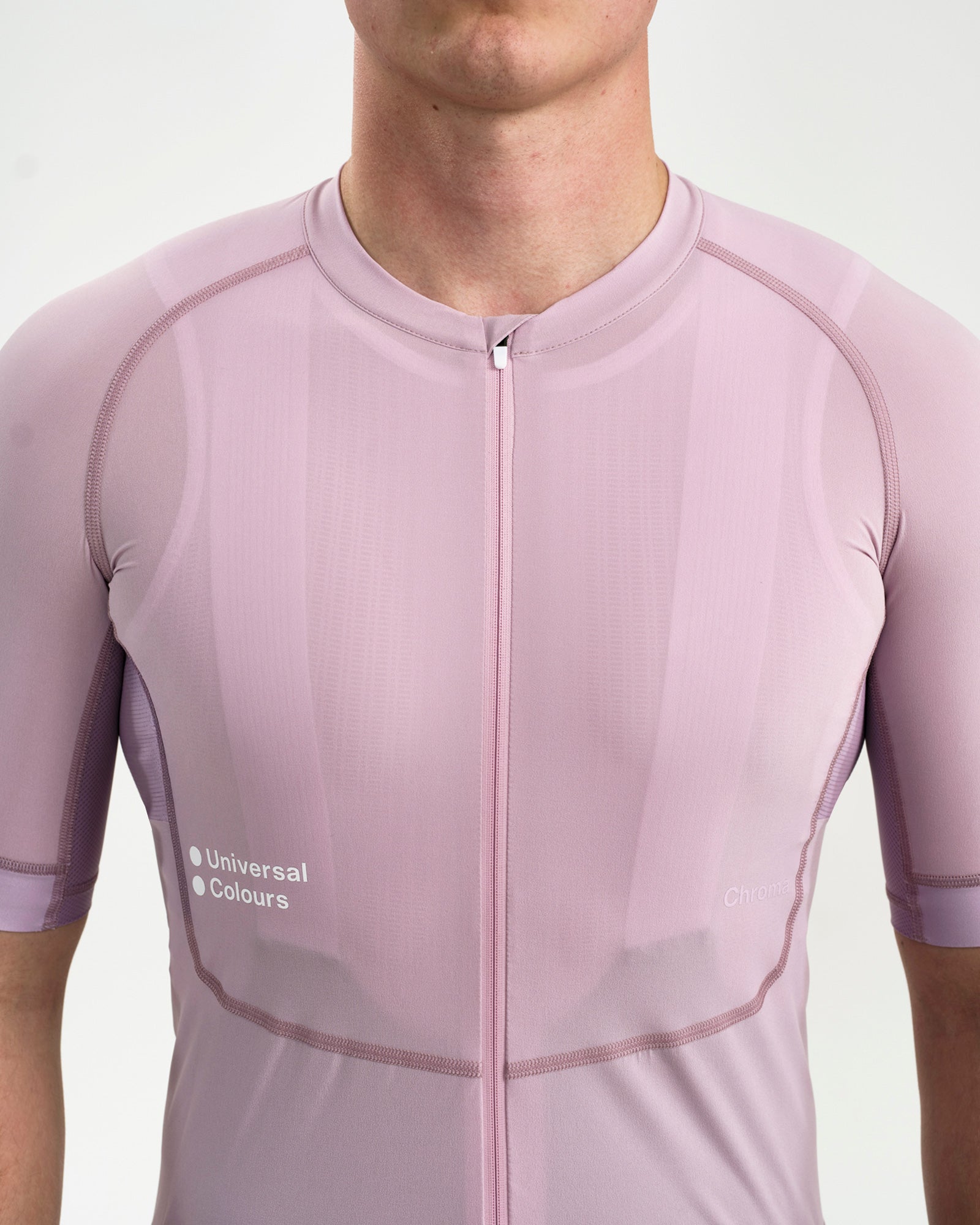 Chest crop: raglan seams, central zip and Universal Colours and Chroma wordmarks on the Washed Lilac Chroma Jersey.