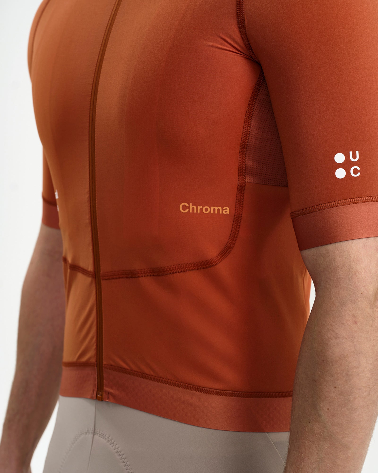 Side mesh ventilation panel on the Men's Chroma Short Sleeve Jersey in Cyprus Copper, with tonal Chroma wordmark detail.