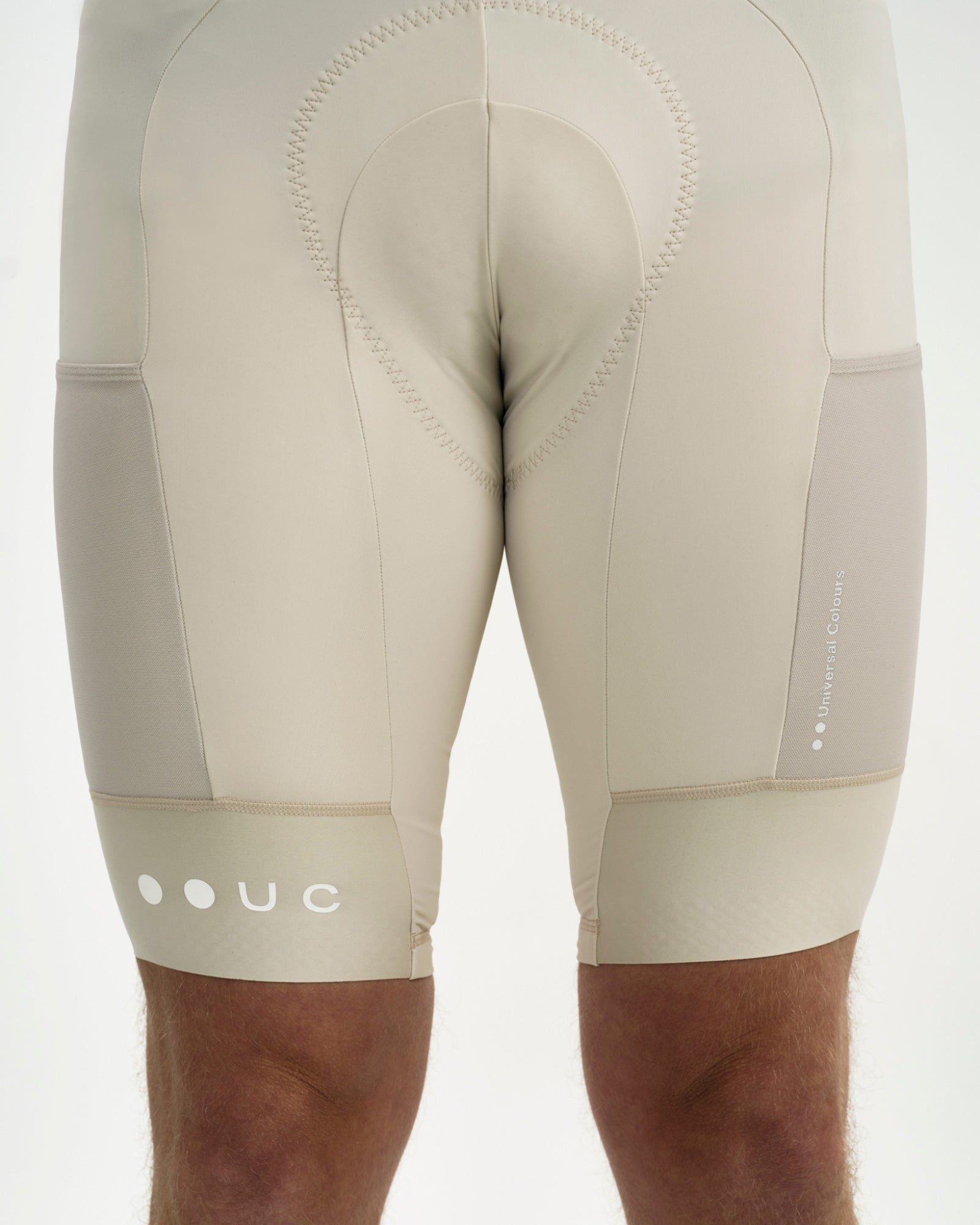 Rear detail of the Men's Mono Cargo Bib Shorts in Off White: contour-stitched chamois, twin cargo pockets and UC hem logo.