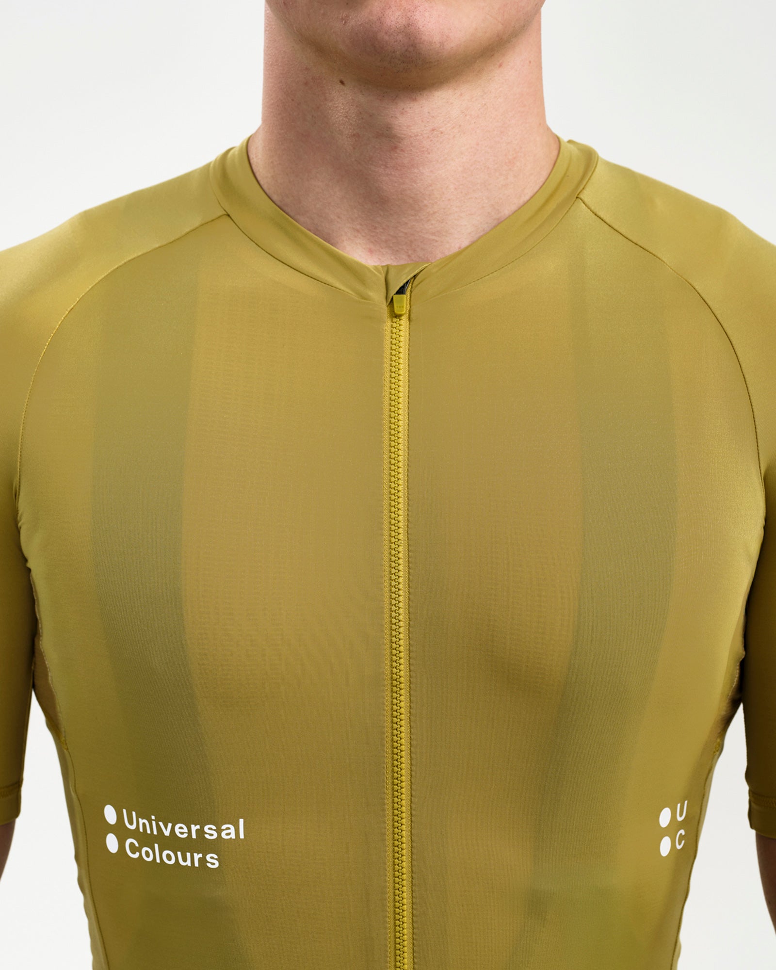 Neckline and full-length zip close-up on the Men's Mono Short Sleeve Jersey in Acidic Yellow with raglan sleeve seams.