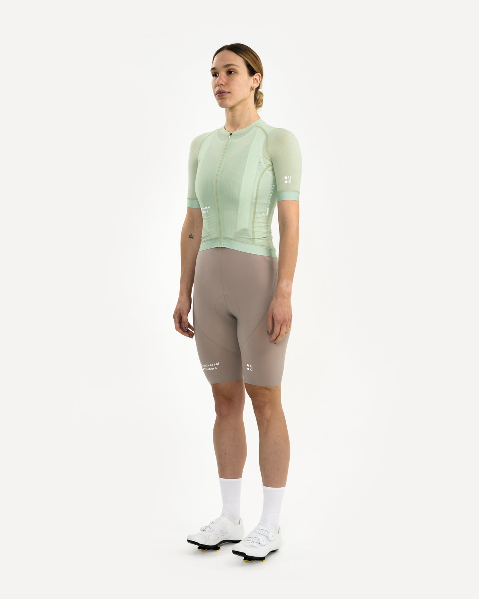 Model wearing the Women's Chroma Light Jersey in Bower Green, front three-quarter, paired with mushroom UC bib shorts.