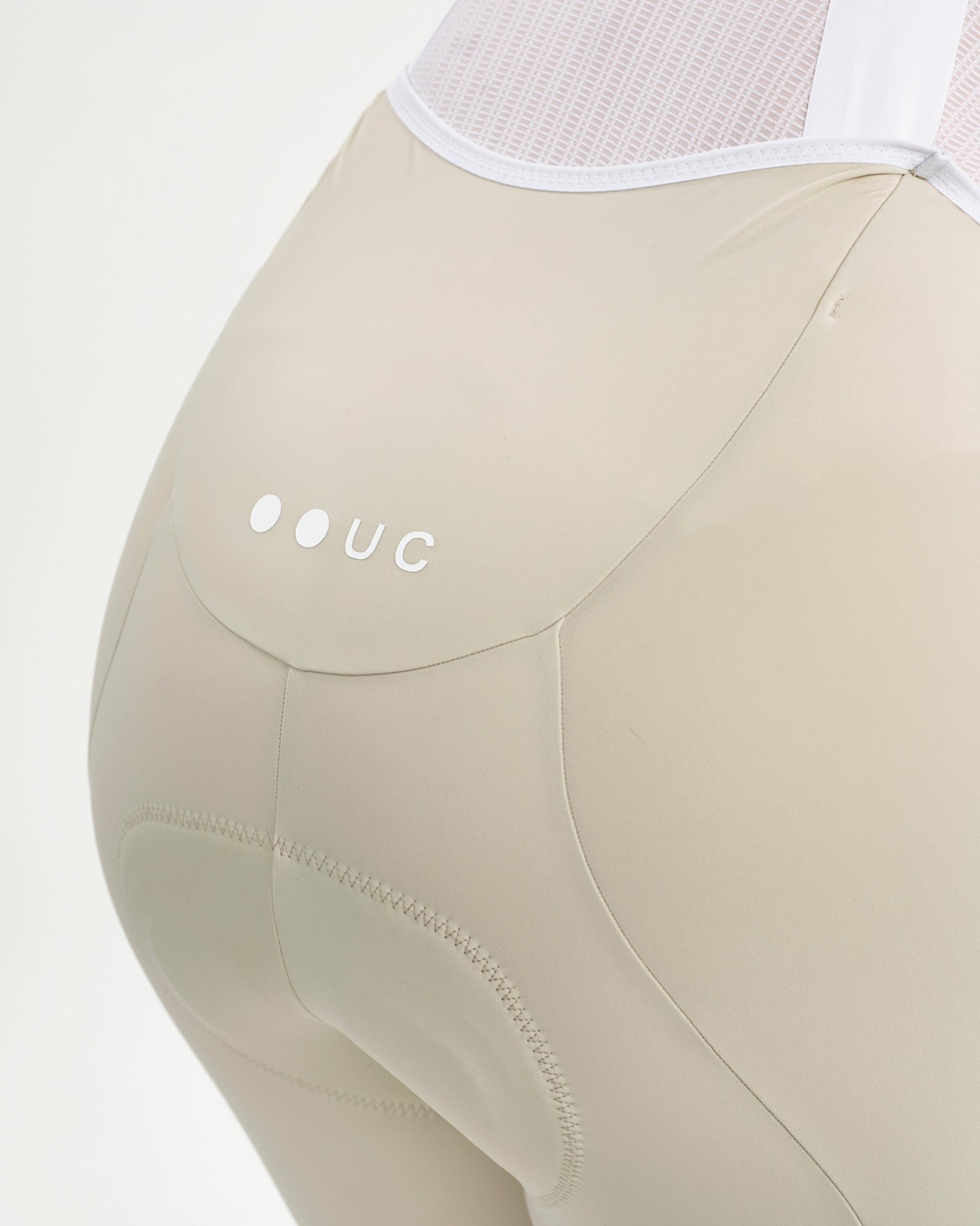 Back yoke close-up: tonal UC logo and stretch panel above the embossed chamois on the Off White Mono Bib Shorts 2.0.
