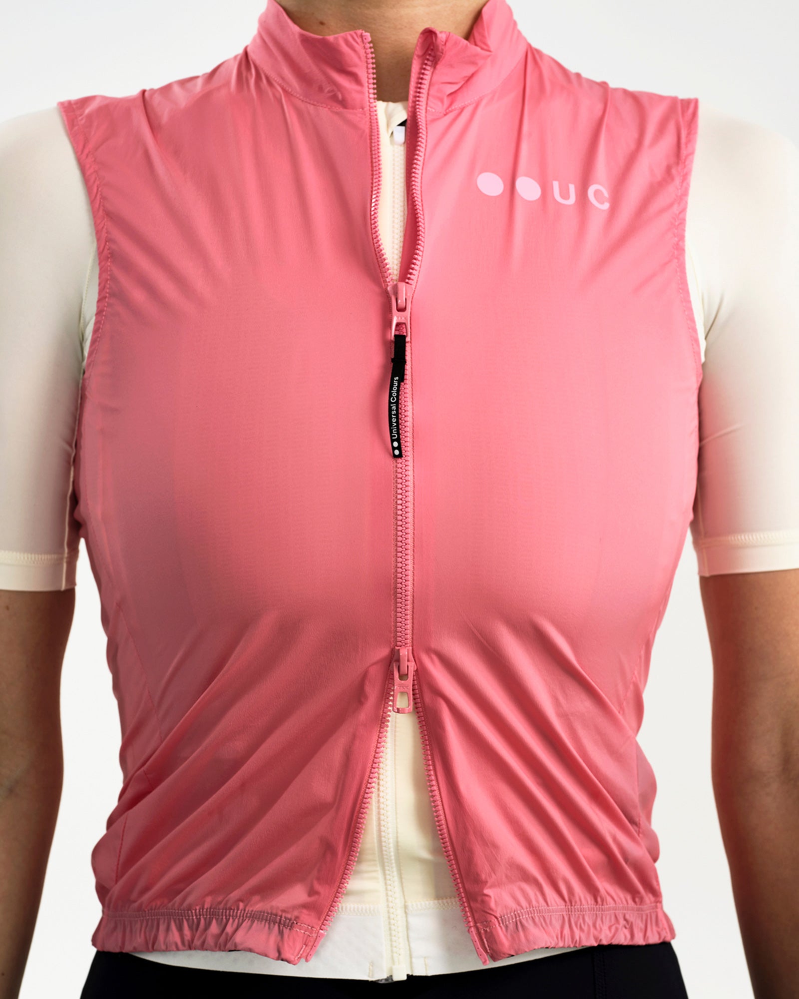Front torso detail of the Women's Mono Gilet 2.0 in Washed Pink, full zip closed over a cream short-sleeve cycling jersey.
