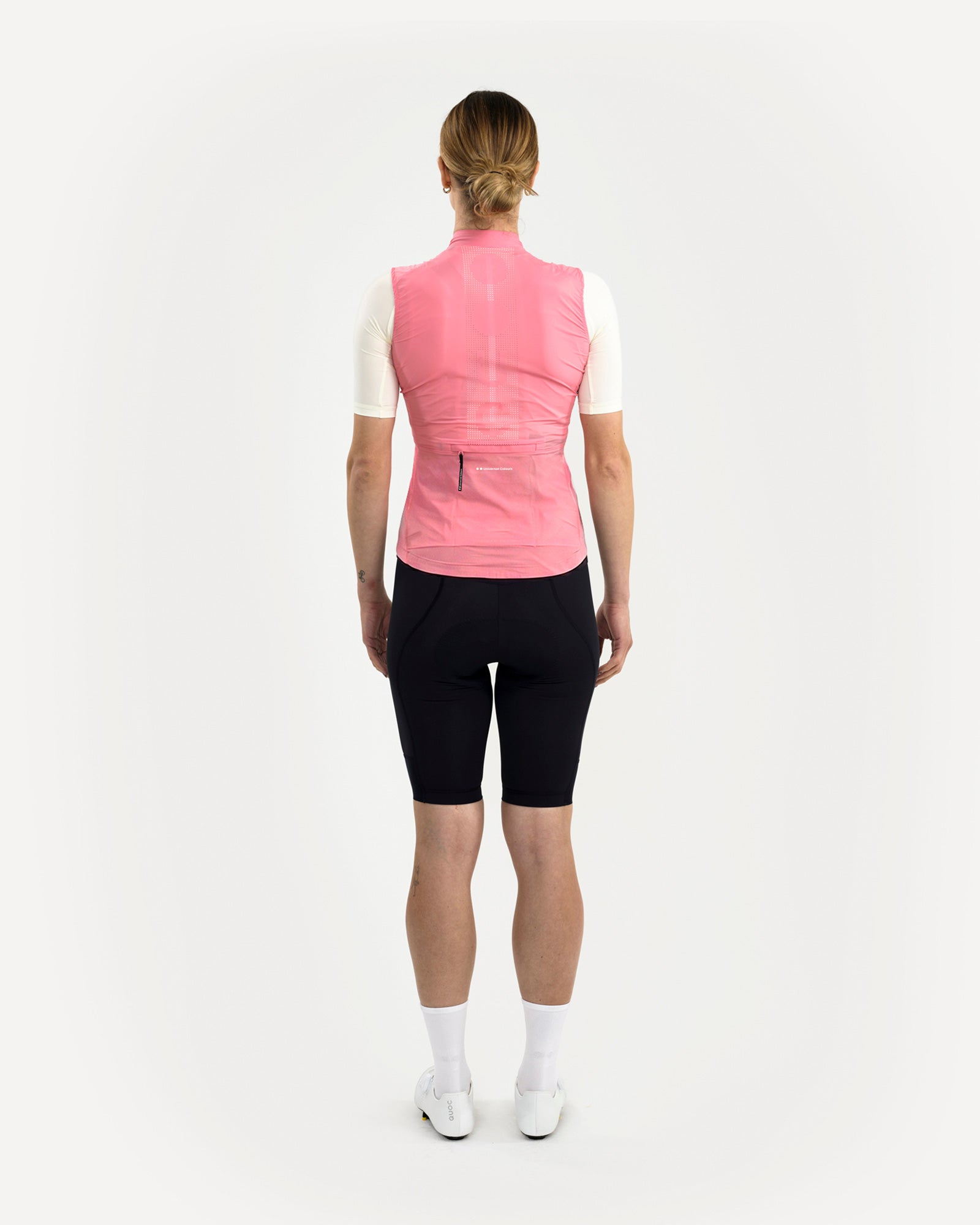 Back view of the Women's Mono Gilet 2.0 in Washed Pink, layered over a cream jersey with perforated mesh back panel visible.
