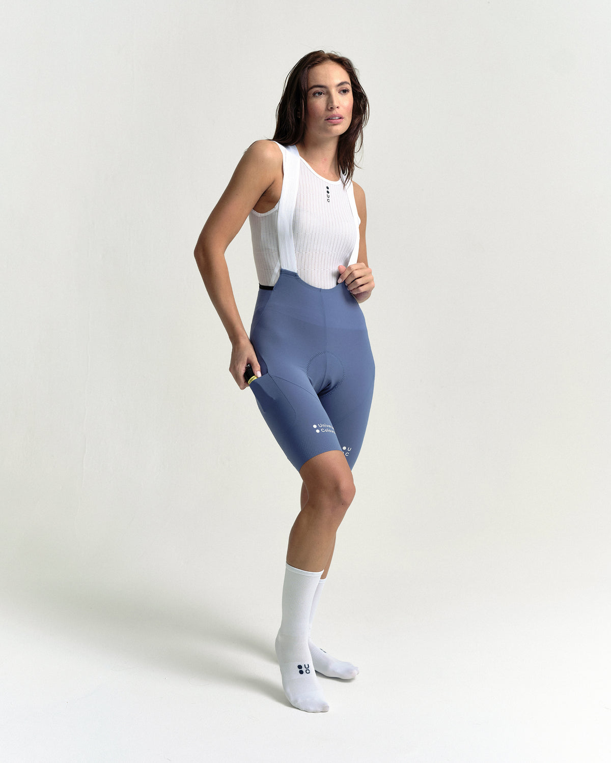 Model in the Women's Chroma Cargo Bib Shorts in Slate Blue, full-length view.