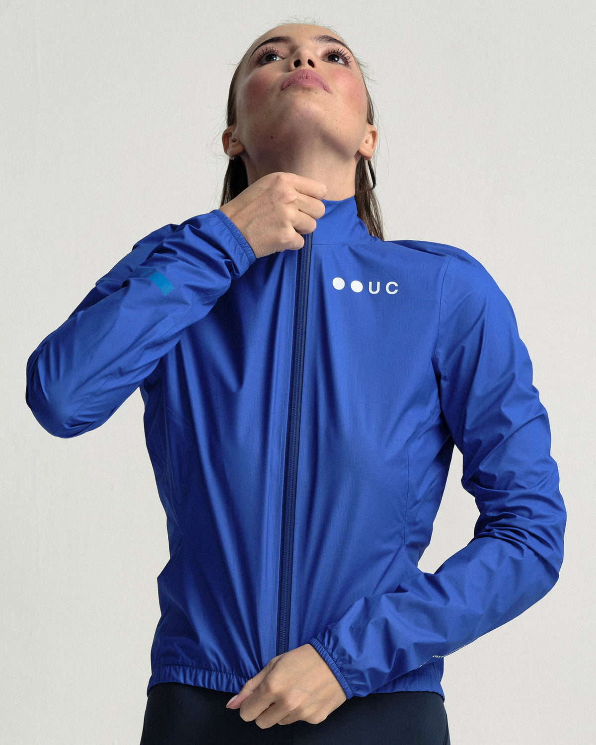 Model wearing the Women's Mono Rain Jacket in Vivid Blue.