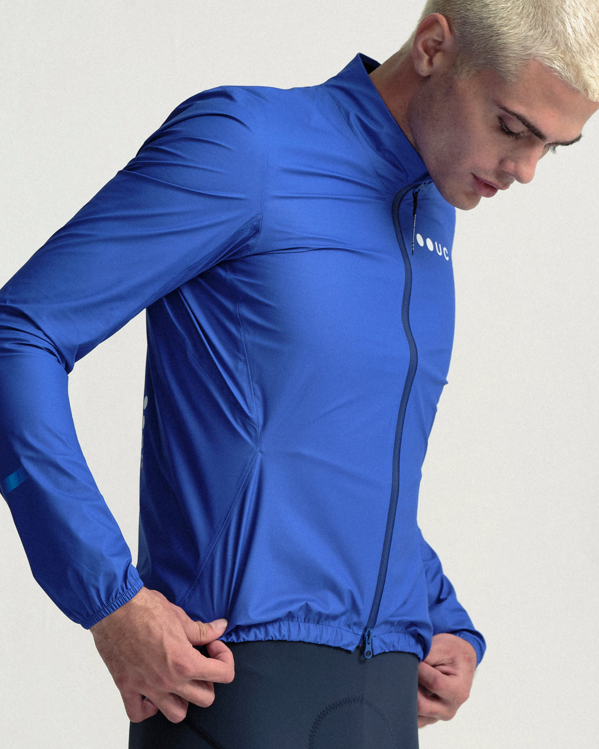 Model wearing the Men's Mono Rain Jacket in Vivid Blue.