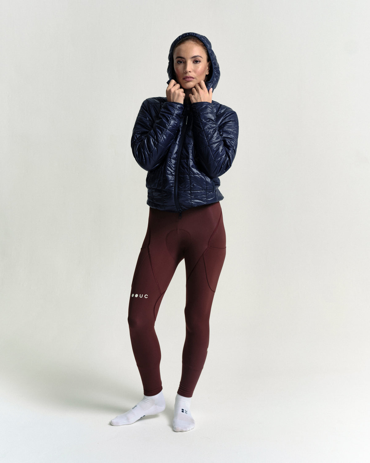 Model wearing the Unisex Insulated Packable Jacket in Ink Blue.