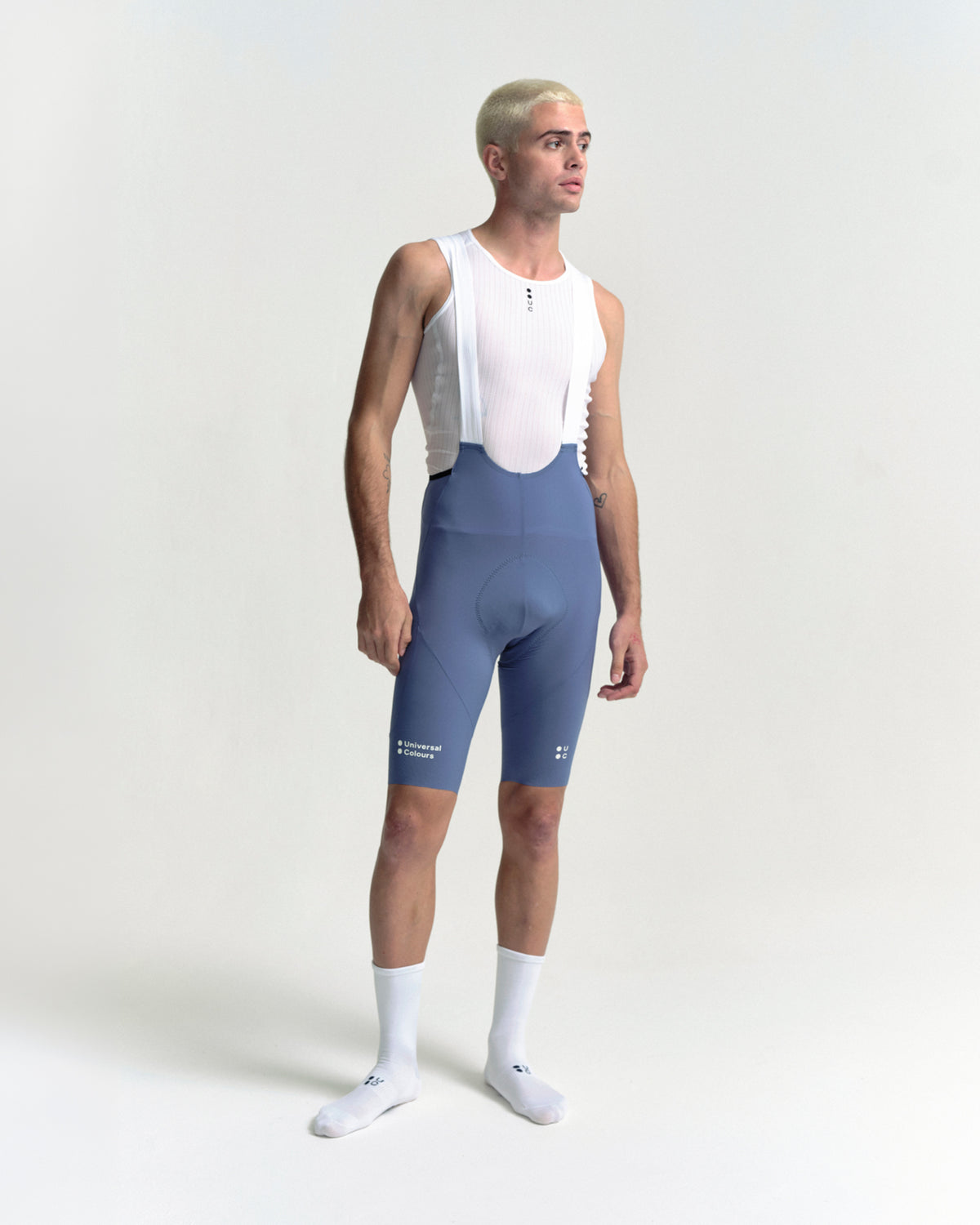 Model wearing the Men's Chroma Cargo Bib Shorts in Slate Blue.