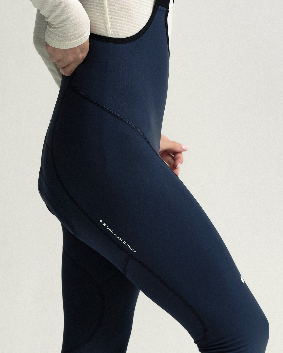 Model wearing the Women's Mono Bib Tight in Eclipse Navy.