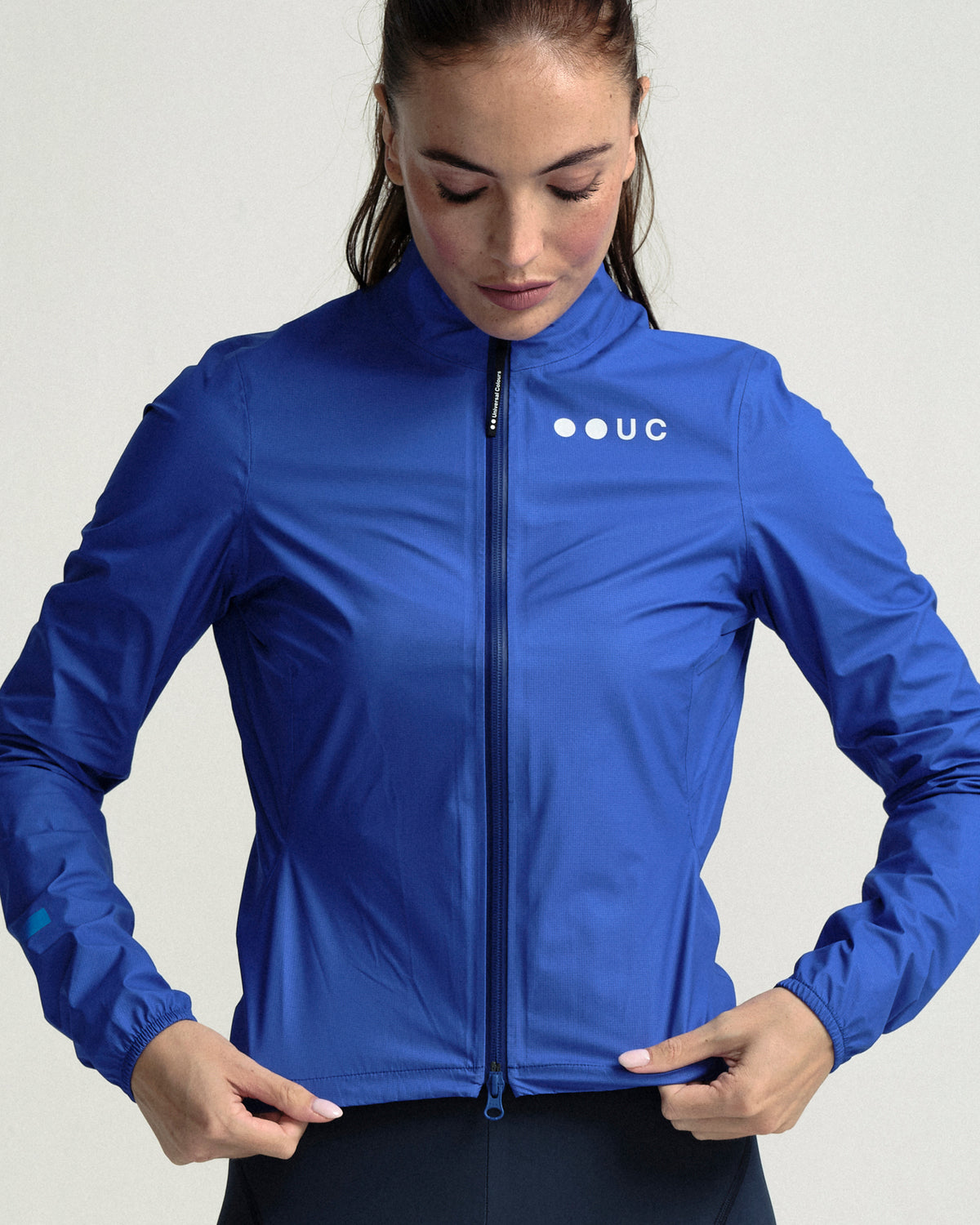 Model wearing the Women's Mono Rain Jacket in Vivid Blue.