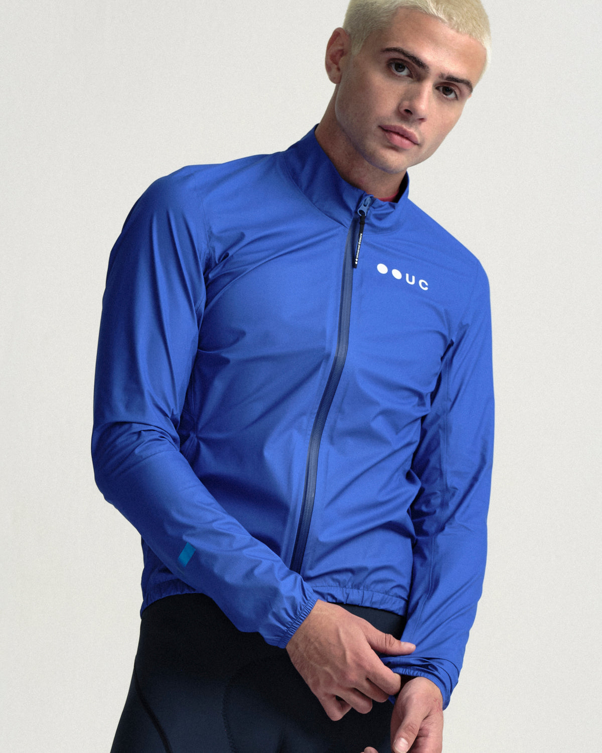 Model wearing the Men's Mono Rain Jacket in Vivid Blue.
