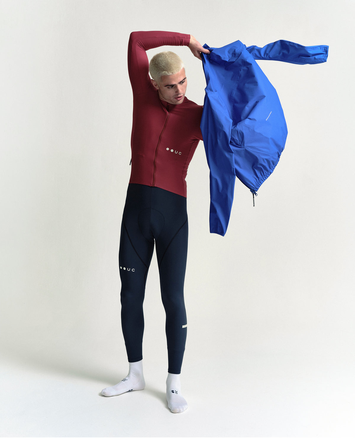 Model wearing the Men's Mono Rain Jacket in Vivid Blue.
