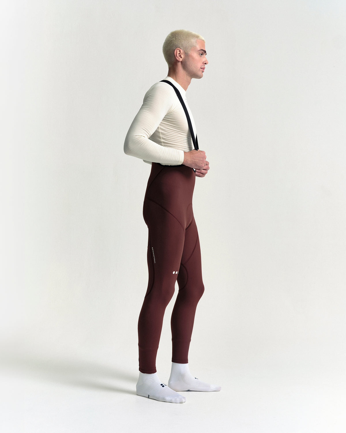 Model wearing the Men's Mono Bib Tight in Deep Red.