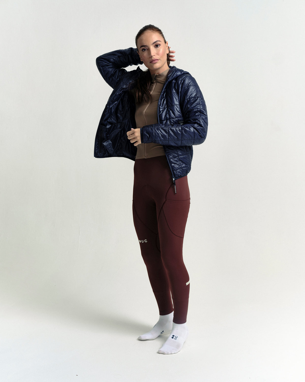 Model wearing the Unisex Insulated Packable Jacket in Ink Blue.