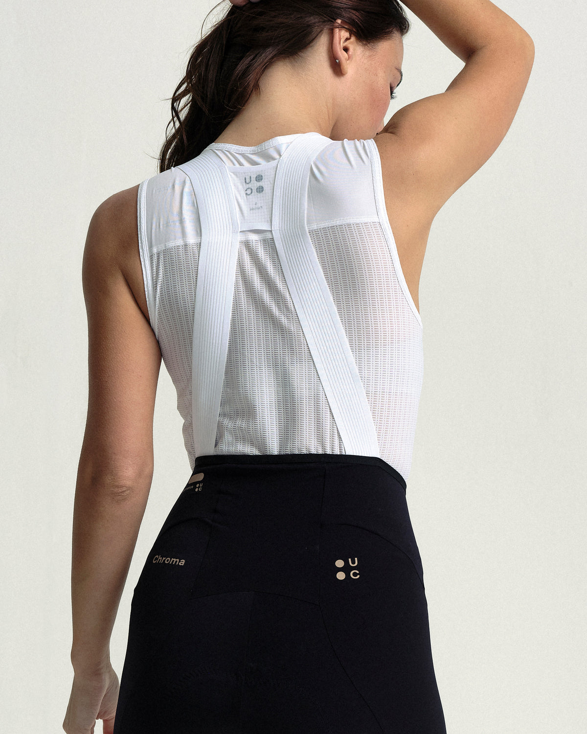 Back view of the Women's Chroma Bib Shorts in Black/Bronze: mesh back panel and straps.