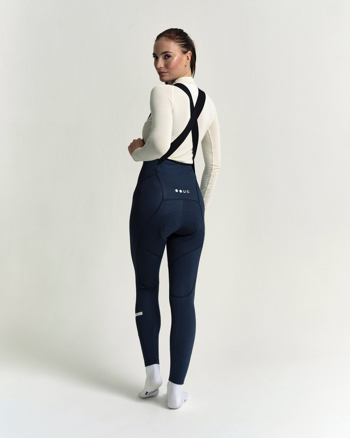 Model wearing the Women's Mono Bib Tight in Eclipse Navy.