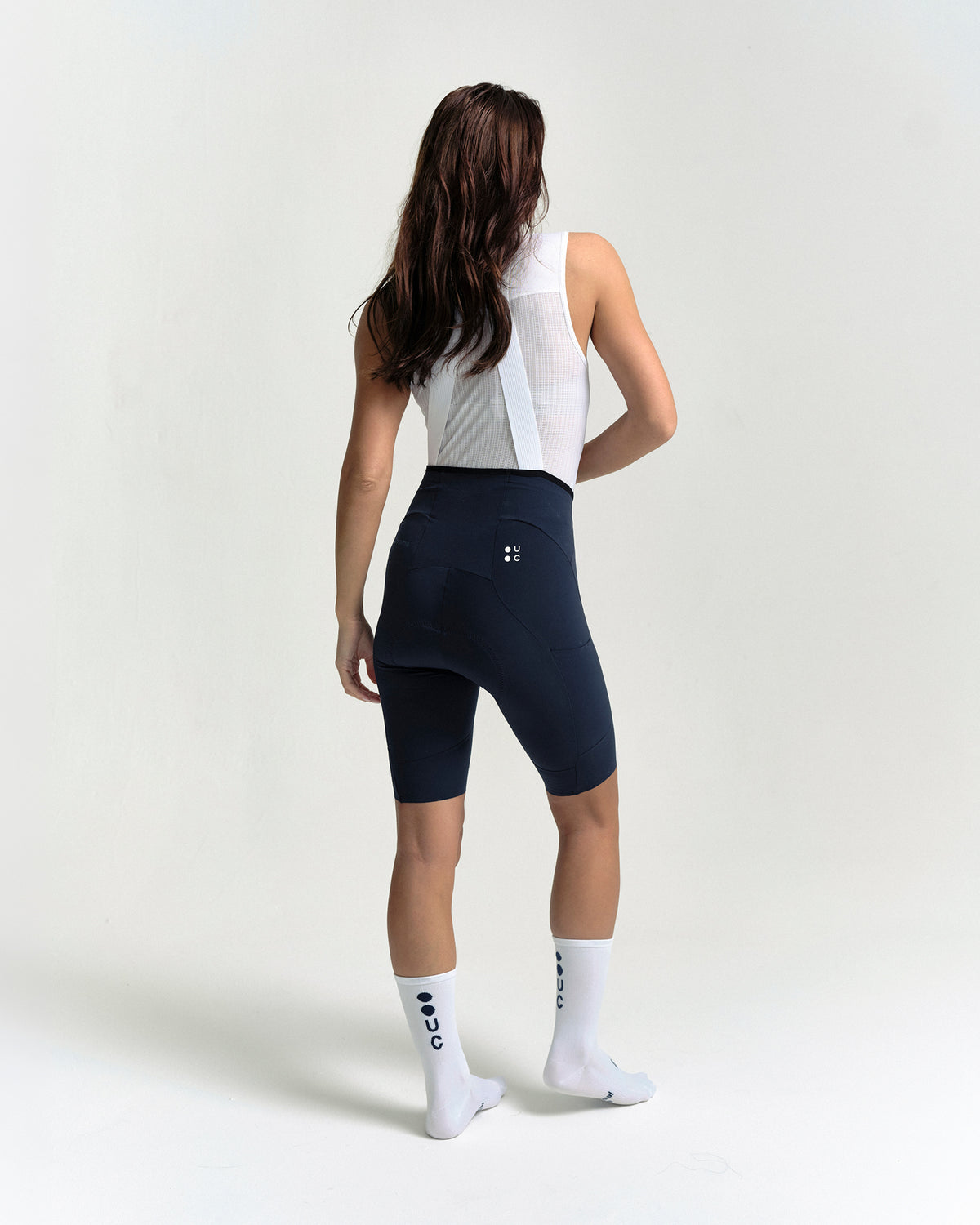Model wearing the Women's Chroma Cargo Bib Shorts in Navy Blue.
