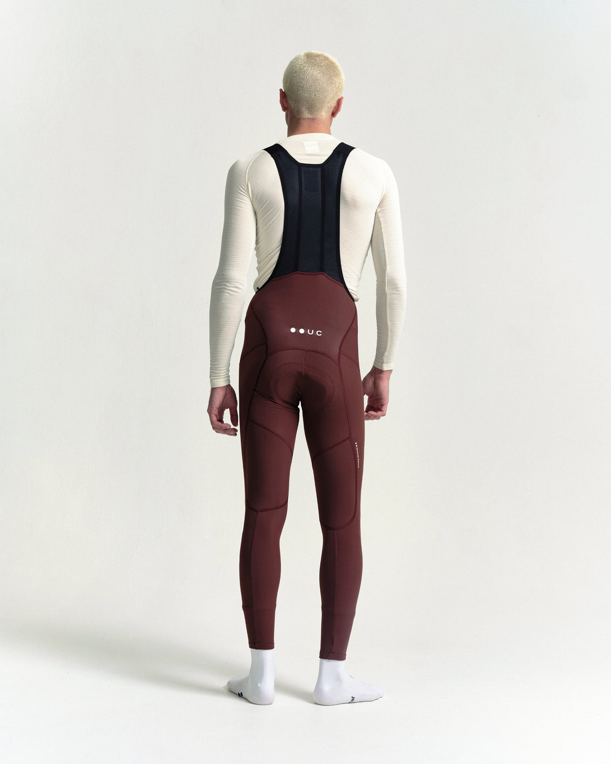 Model wearing the Men's Mono Bib Tight in Deep Red.