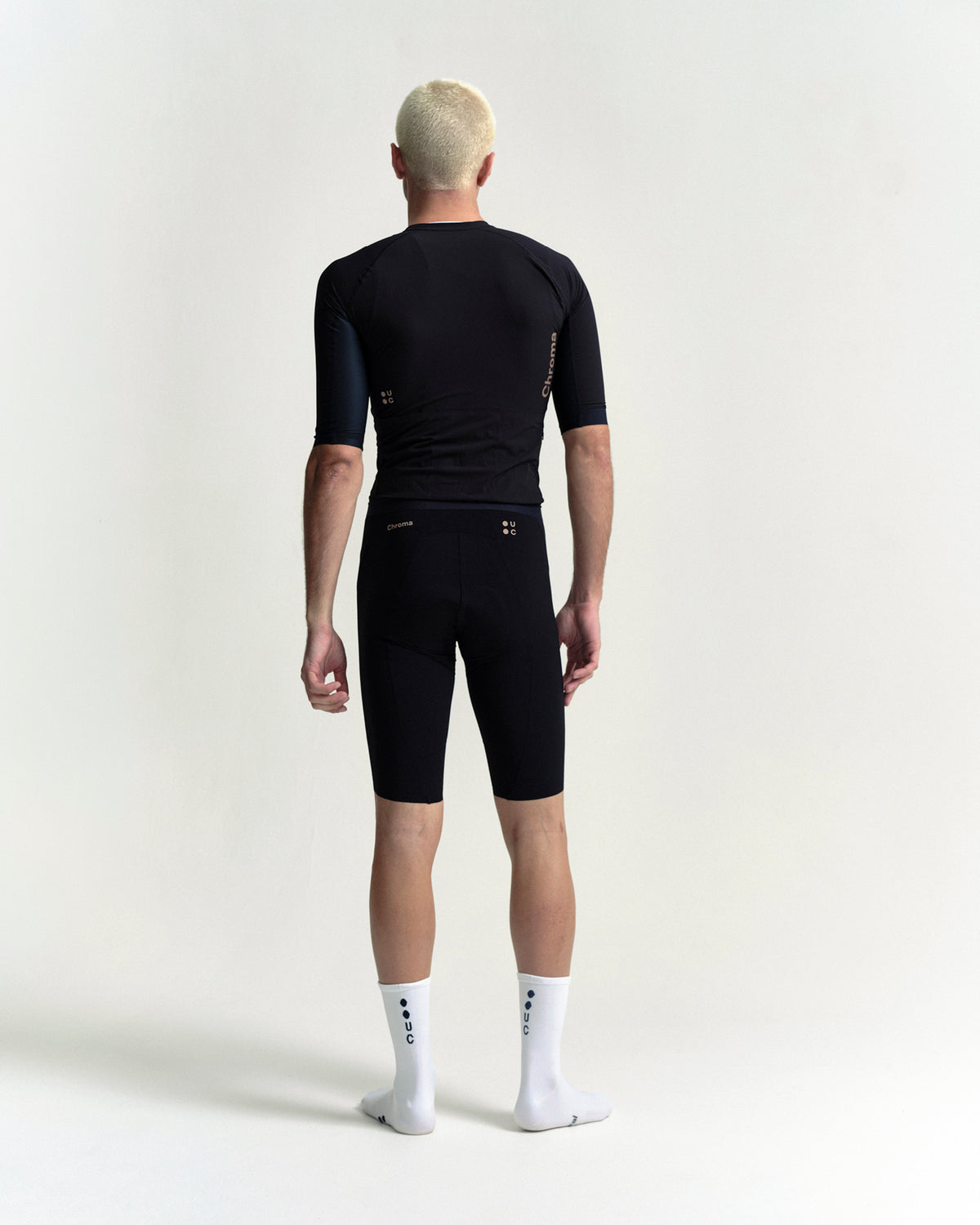 Model wearing the Men's Chroma Bib Shorts in Black/Bronze.