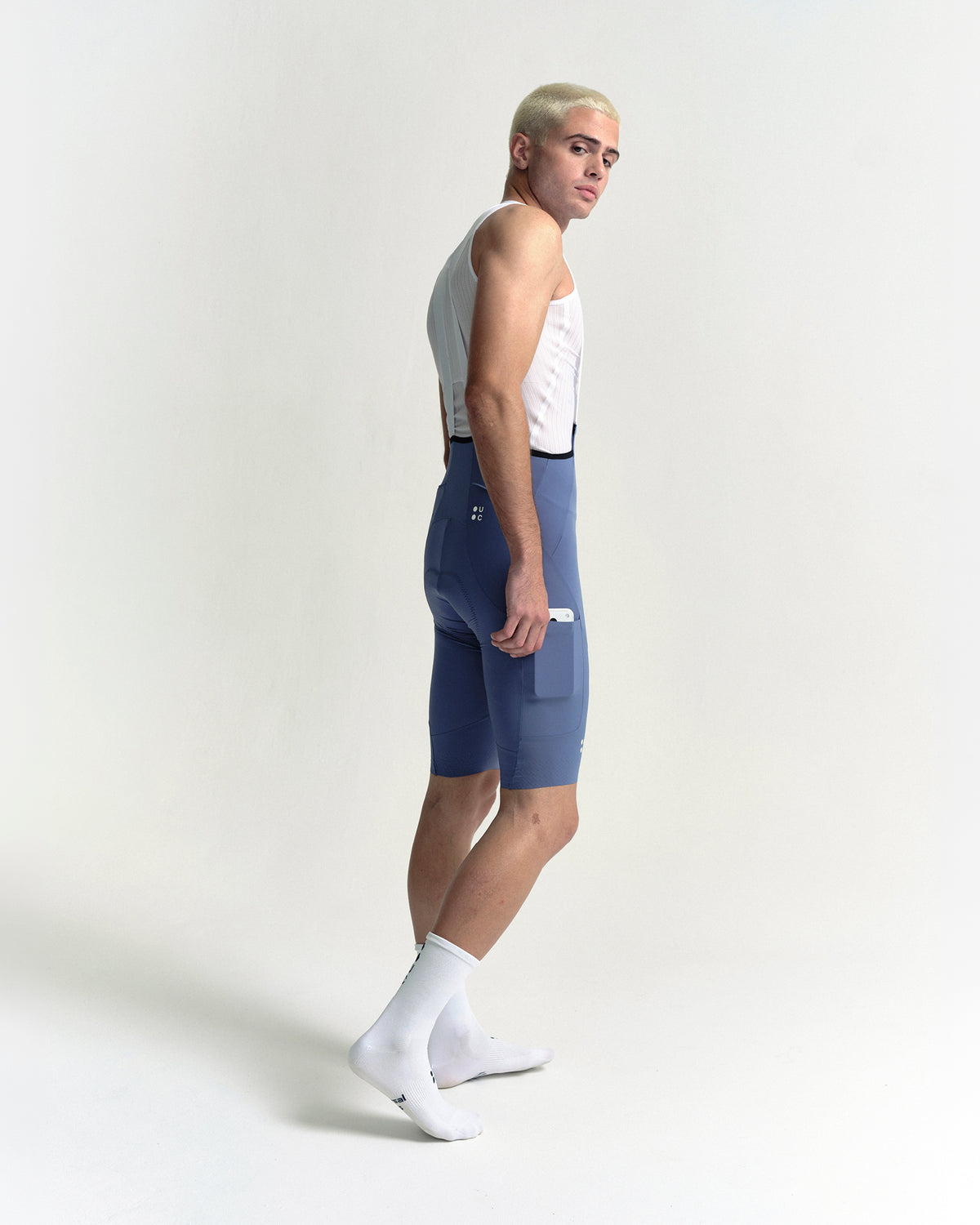 Model wearing the Men's Chroma Cargo Bib Shorts in Slate Blue.