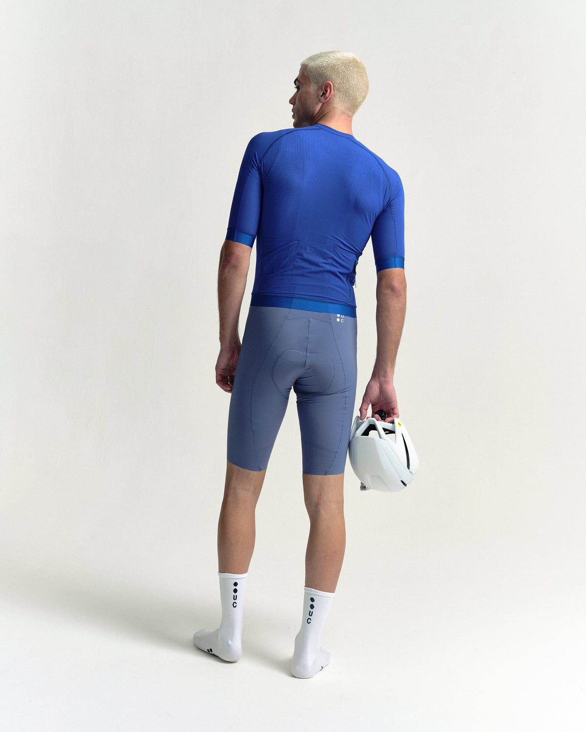 Model wearing the Men's Chroma Light Short Sleeve Jersey in Vivid Blue.