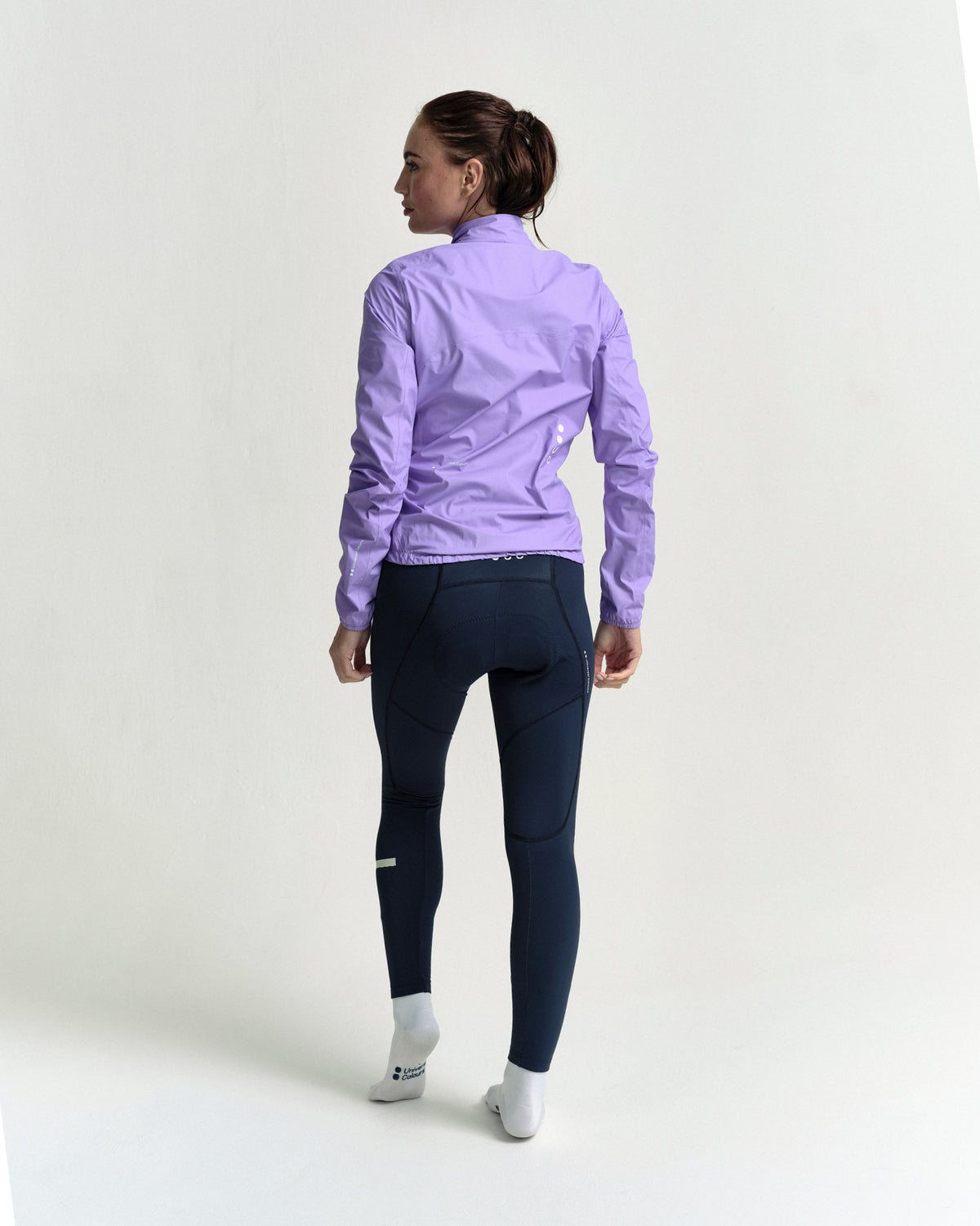Model in the Women's Mono Rain Jacket in Cloud Lilac, full-length back view.
