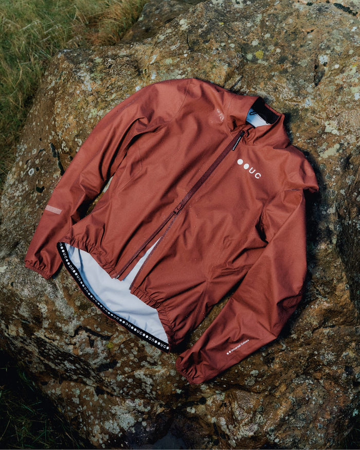 Waterproof cycling jacket on rock