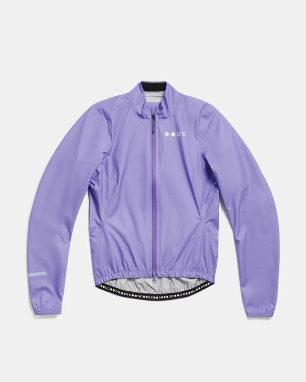Flatlay of the Women's Mono Rain Jacket in Cloud Lilac: high collar, full-length zip, UC chest logo, elasticated hem.