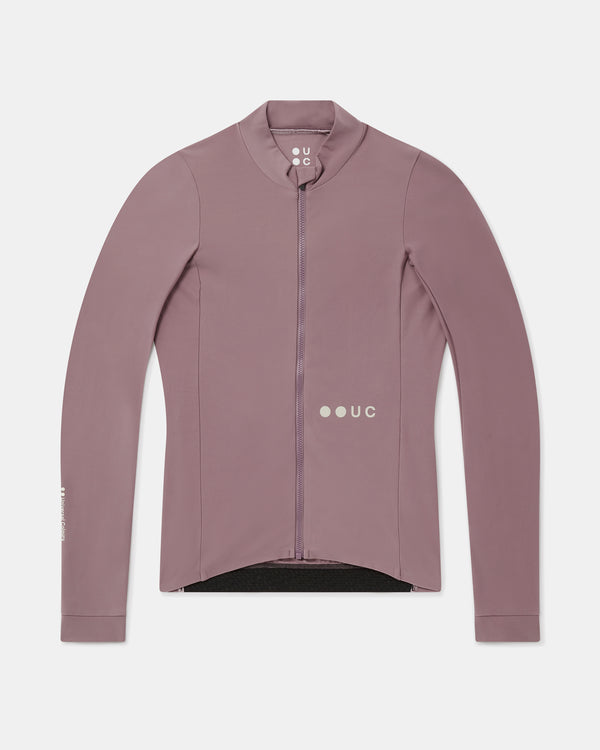 Flatlay of the Women's Mono Long Sleeve Jersey in Mauve Mist: full-length front zip, high collar and UC logo.