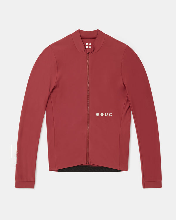 Flatlay of the Men's Mono Long Sleeve Jersey in Apple Red: mock collar, full-length zip and UC logo.