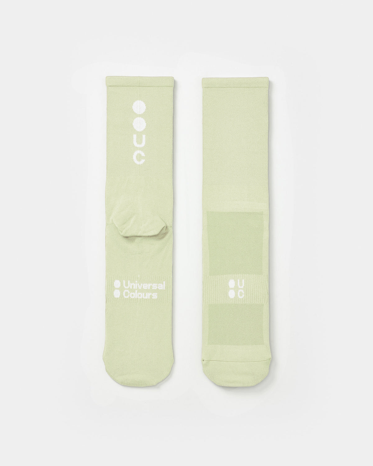 Flatlay of the Mono Summer Socks in Tea: vertical UC logo on the cuff, horizontal UC mark on the foot.