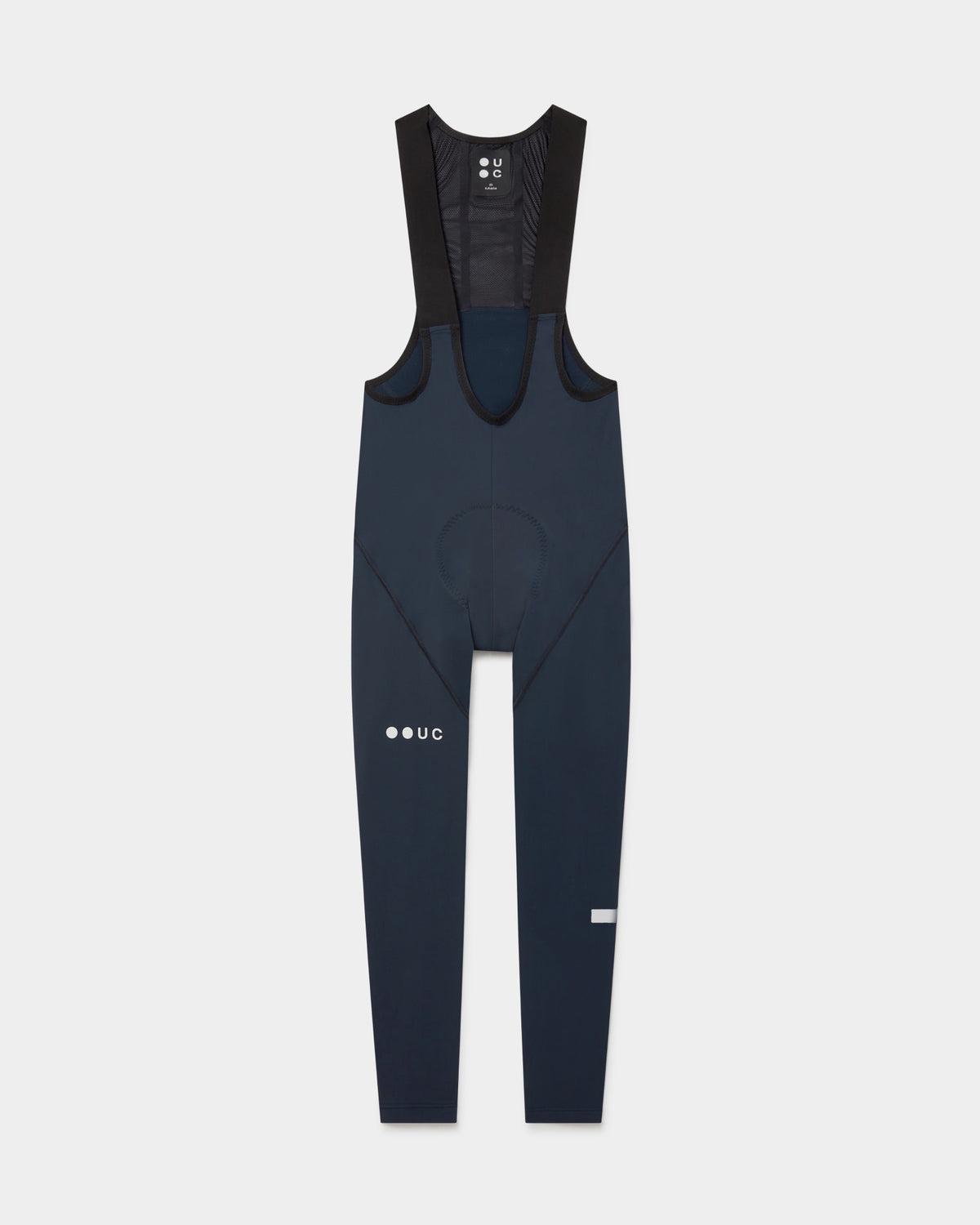 Flatlay of the Men's Mono Bib Tight in Eclipse Navy: mesh bib straps, contoured chamois and UC thigh logo.