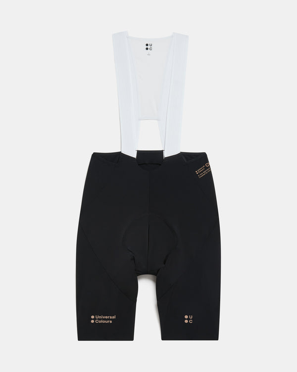 Flatlay of the Men's Chroma Bib Shorts in Black/Bronze: ribbed bib straps, mesh bib upper and Universal Colours leg logos.