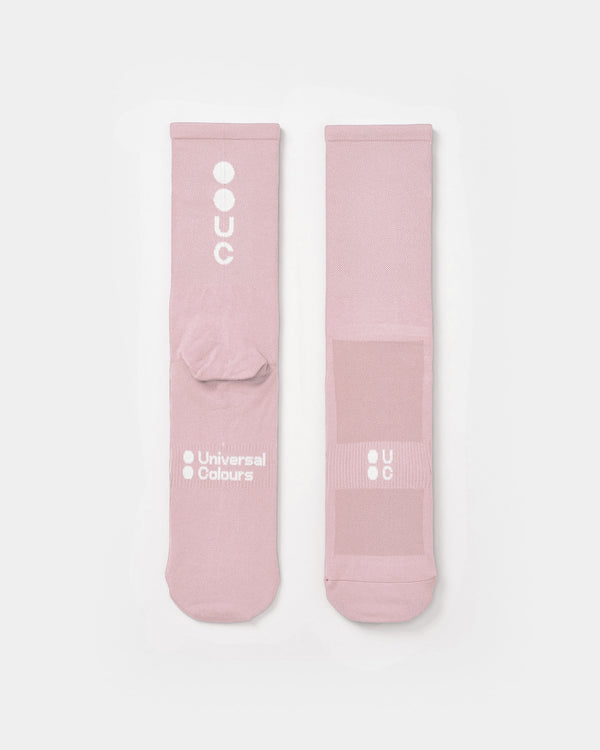 Flatlay of the Mono Summer Socks in Washed Pink: vertical UC logo on the cuff, horizontal UC mark on the foot.