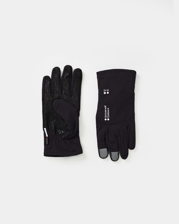 Flatlay of the Mono Thermal Gloves in Black: UC-dot silicone grip palm with Polartec label, and UC logo on the back.