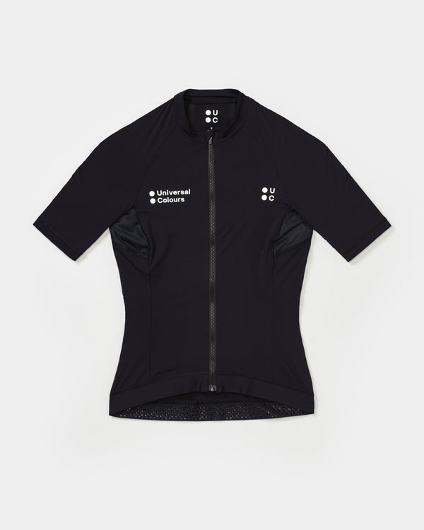 Flatlay: Women's Mono Short Sleeve Jersey in Black, full-length zip, mesh side panels and dual white UC chest logos.