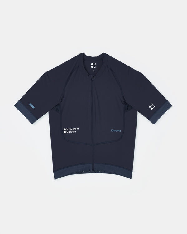 Flatlay of the Men's Chroma Short Sleeve Jersey in Midnight Blue: full-length zip, UC chest logo, Chroma wordmark on hip.