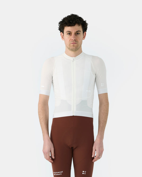 Model wearing the Men's Chroma Short Sleeve Jersey in Off White, paired with Heavy Bark Brown Chroma bib shorts.