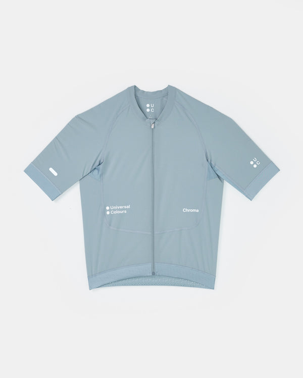 Flatlay: Men's Chroma Short Sleeve Jersey in Sky Blue, full-length zip, contrast lighter blue cuffs and tonal UC sleeve logo.