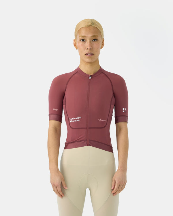 Model wearing the Women's Chroma Short Sleeve Jersey in Jaipur Red, paired with cream bib shorts, front view.