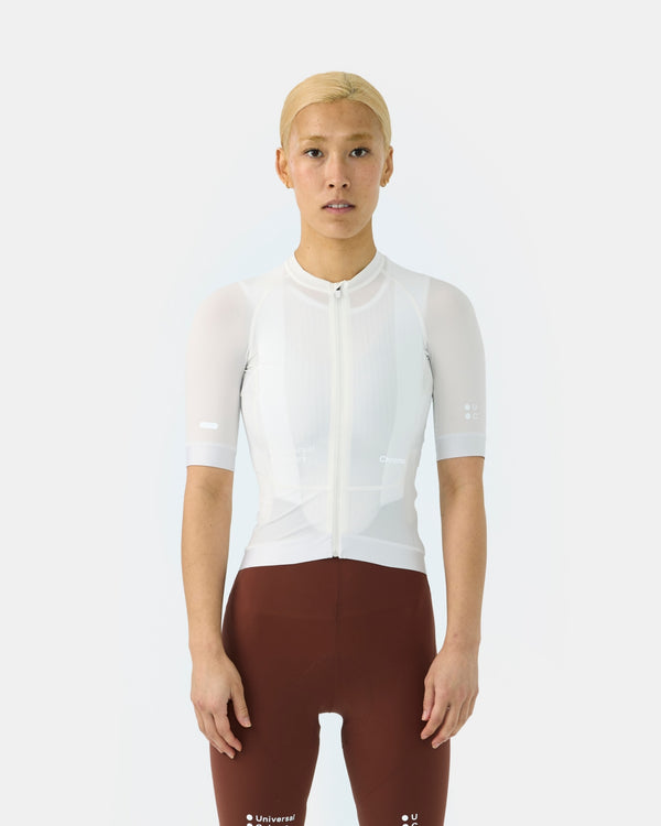 Model wearing the Women's Chroma Short Sleeve Jersey in Off White, paired with brown bib shorts, front view.