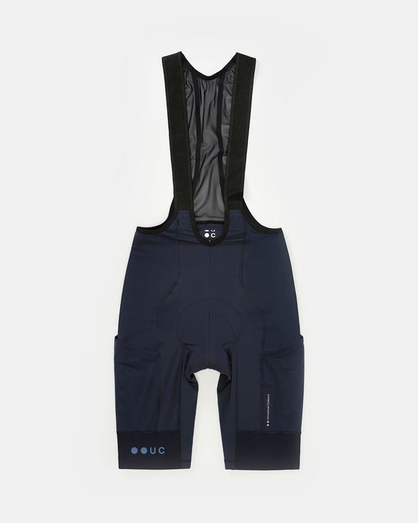 Flatlay, Men's Mono Cargo Bib Shorts in Navy Blue: ribbed bib straps, mesh back, rear pocket, twin side cargo pockets.